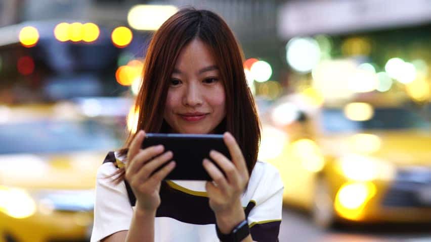 Image result for woman playing game on smartphone
