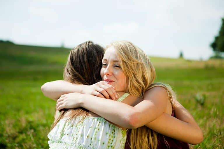 Image result for woman hugging friend